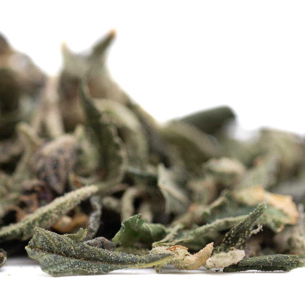 Pineapple Express THCa trim with green sage leaves and herbal tea blend