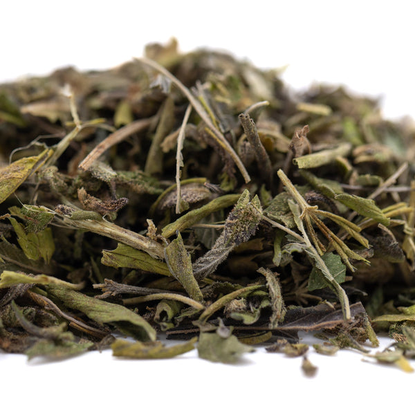 Green dried sage leaves pile with Sunset Sherbet THCa trim hemp flower blend